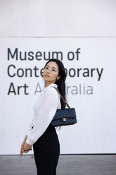 a lady in a white shirt and a pair of black pants